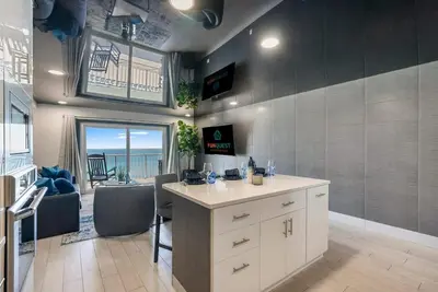 a kitchen with a counter and a view of the ocean at The Summit 1205 in Panama City Beach