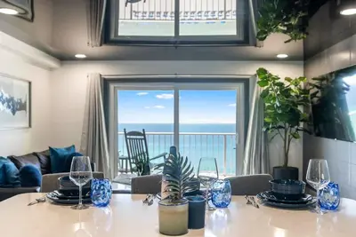 a dining room with a table with a view of the ocean at The Summit 1205 in Panama City Beach