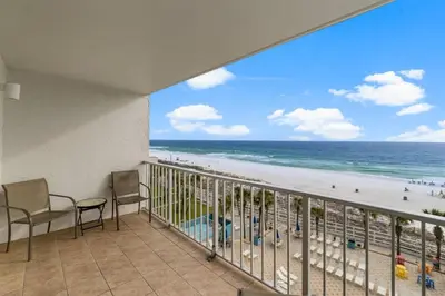 a balcony with chairs and a view of the beach at The Summit 620 in Panama City Beach