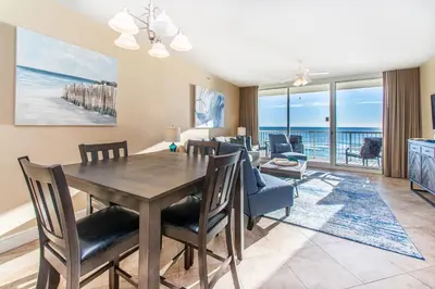 a dining room and living room with a table and chairs at Majestic Beach Towers 2-403 in Panama City Beach