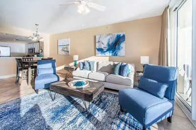 a living room with a white couch and blue chairs at Majestic Beach Towers 2-403 in Panama City Beach
