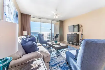 a living room with a couch and chairs and a tv at Majestic Beach Towers 2-403 in Panama City Beach