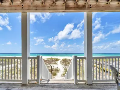a view of the beach from the porch of a beach house at Ocean Spray in Panama City