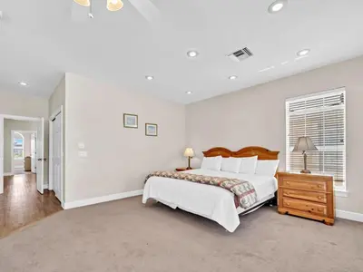 a white bedroom with a large bed and a window at Ocean Spray in Panama City
