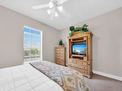 a bedroom with a bed and a tv and a window at Ocean Spray in Panama City