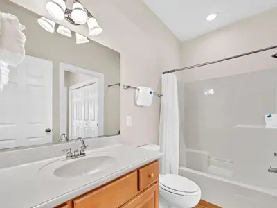 a white bathroom with a sink and a toilet at Ocean Spray in Panama City