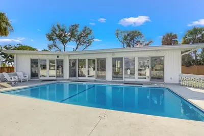 a swimming pool in front of a house at Bay Shore in Panama City Beach