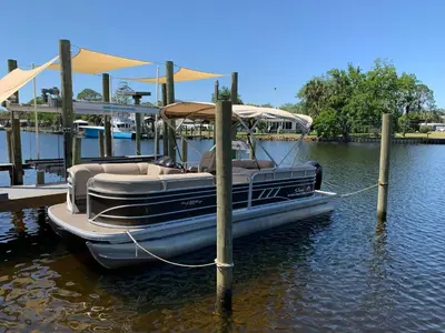a boat tied up to a dock in the water at Bay Shore in Panama City Beach