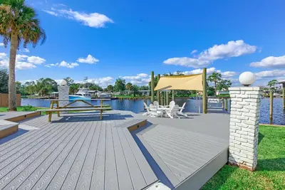 a wooden deck with a picnic table and a tent at Bay Shore in Panama City Beach