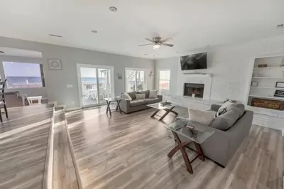 a living room with a couch and a fireplace at Sandy Feet Retreat in Panama City Beach