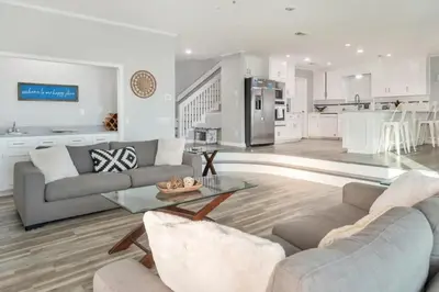a living room with a couch and a table at Sandy Feet Retreat in Panama City Beach