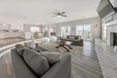 a large living room with a couch and a fireplace at Sandy Feet Retreat in Panama City Beach