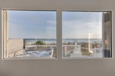 a window with a view of a hot tub at Sandy Feet Retreat in Panama City Beach