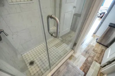 a walk in shower with a glass door at Sea Glass Villa in Panama City Beach