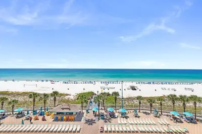 an aerial view of a beach with chairs and umbrellas at The Summit 616 in Panama City Beach
