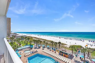 a view of the beach from the balcony of a resort at The Summit 616 in Panama City Beach