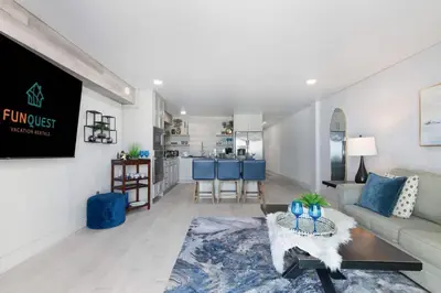 a living room with a couch and a kitchen at The Summit 616 in Panama City Beach