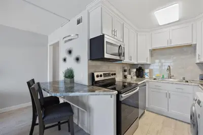 a kitchen with white cabinets and a counter top at The Summit 621 in Panama City Beach