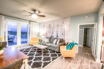 a living room with a couch and chairs at Laketown Wharf 429 By Aneliya in Panama City Beach