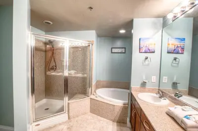 a bathroom with a shower and a sink and a tub at Laketown Wharf 429 By Aneliya in Panama City Beach