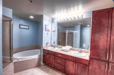 a bathroom with two sinks and a tub and a bath tub at Laketown Wharf 429 By Aneliya in Panama City Beach