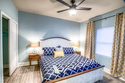 a bedroom with a bed and a ceiling fan at Laketown Wharf 429 By Aneliya in Panama City Beach