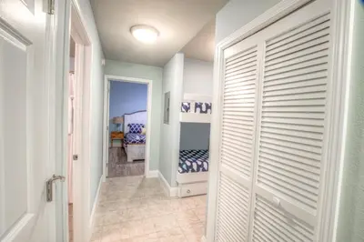 a hallway with a door leading to a bedroom at Laketown Wharf 429 By Aneliya in Panama City Beach