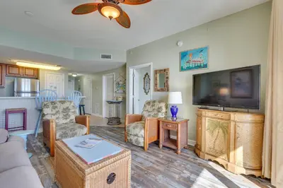 a living room with a flat screen tv and a couch at Gulf Coast Getaway with Balcony and Resort Amenities! in Panama City Beach