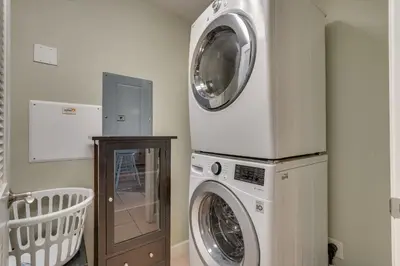 a laundry room with a washer and a dryer at Gulf Coast Getaway with Balcony and Resort Amenities! in Panama City Beach