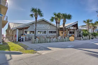 a store with palm trees in front of a building at Gulf Coast Getaway with Balcony and Resort Amenities! in Panama City Beach