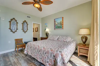 a bedroom with a bed and a ceiling fan at Gulf Coast Getaway with Balcony and Resort Amenities! in Panama City Beach