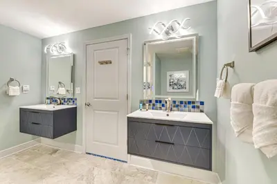 a bathroom with two sinks and a mirror at Panama City Beachfront Condo with Breathtaking Views in Panama City Beach