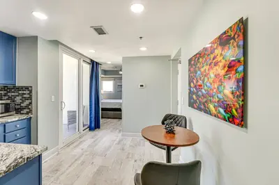a kitchen with a table and a painting on the wall at Panama City Beachfront Condo with Breathtaking Views in Panama City Beach