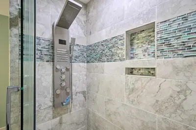 a bathroom with a shower with a glass door at Chic Panama City Beach Condo with Pool and Gulf Views in Panama City Beach