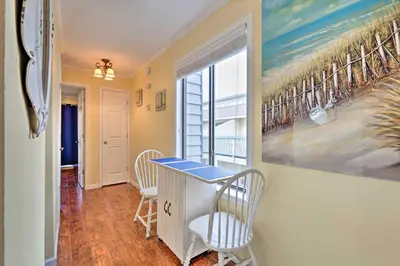 a room with a table and chairs and a window at Convenient PCB Condo with Pool Access Walk to Beach in Panama City Beach