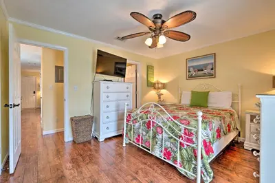 a bedroom with a bed and a ceiling fan at Convenient PCB Condo with Pool Access Walk to Beach in Panama City Beach