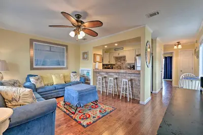 a living room with a couch and a ceiling fan at Convenient PCB Condo with Pool Access Walk to Beach in Panama City Beach