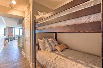 a couple of bunk beds in a room at Oceanfront PCB Condo with Balcony and Pool Access! in Panama City Beach