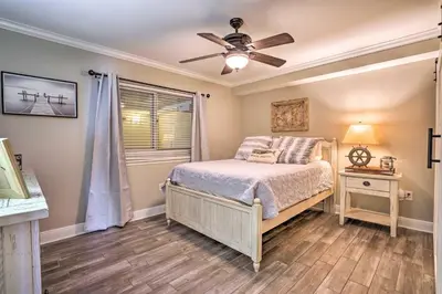 a bedroom with a bed and a ceiling fan at Oceanfront PCB Condo with Balcony and Pool Access! in Panama City Beach