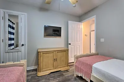 a bedroom with two beds and a tv on the wall at Seagrove Beach Condo with Pool Access Walk to Beach in Seagrove Beach