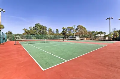 a tennis court with a tennis net on it at Seagrove Beach Condo with Pool Access Walk to Beach in Seagrove Beach