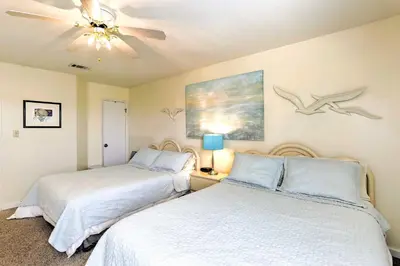 a bedroom with two beds and a ceiling fan at PCB Condo with Pool and Grill Access - Walk to Beach! in Panama City Beach