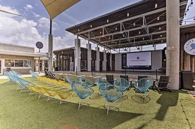 a group of chairs sitting in front of a building at Always Saturday Prominence Resort Townhome! in Inlet Beach