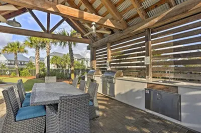 an outdoor patio with a table and a kitchen at Always Saturday Prominence Resort Townhome! in Inlet Beach