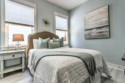 a bedroom with a bed and two windows at Always Saturday Prominence Resort Townhome! in Inlet Beach