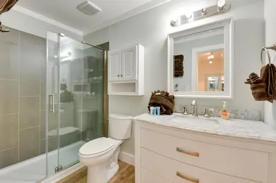 a bathroom with a toilet and a glass shower at Seaside Panama City Beach Condo with Outdoor Pool! in Panama City Beach