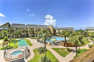 an image of a resort with a swimming pool and palm trees at Seaside Panama City Beach Condo with Outdoor Pool! in Panama City Beach