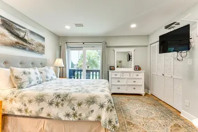 a bedroom with a bed and a flat screen tv at Seaside Panama City Beach Condo with Outdoor Pool! in Panama City Beach