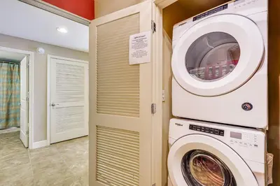 a laundry room with a washer and dryer at Beachfront Panama City Condo Walk to Pier Park! in Panama City Beach