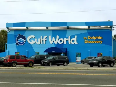 a glut world sign on the side of a store at Beachfront Panama City Condo Walk to Pier Park! in Panama City Beach